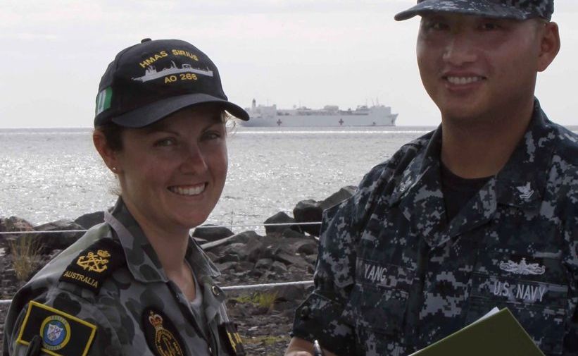 Kylie Faulks discusses the day's activities with a US Navy medcial officer.